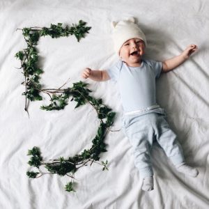 baby smiling with a number