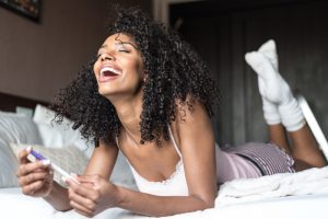 So You Had Unprotected Sex. When Can You Take A Pregnancy Test? 1 happy woman with a pregnancy test